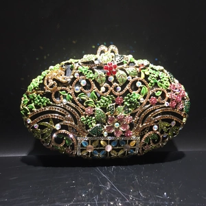 Detailed view of colorful rhinestones and floral enamel on a vintage evening clutch bag