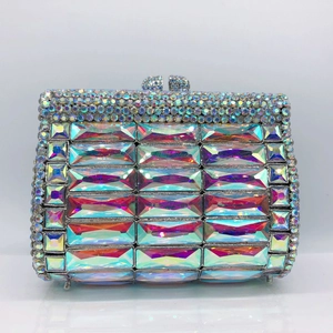 Detailed macro view of luxury clutch bag featuring multi-color crystals and metal frame