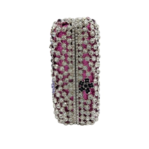 Detail of floral crystal pattern on purple sparkling hard shell evening clutch