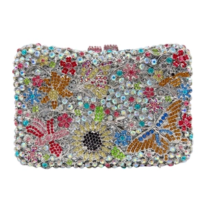 Detailed view of colorful floral pattern and butterfly crystals on luxury clutch bag