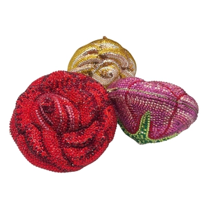 Detail showing crystal-encrusted rose evening bags in red, pink, and champagne gold