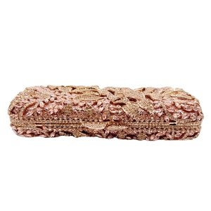 Detail of rose gold evening clutch with floral crystal pavé and metal frame closure
