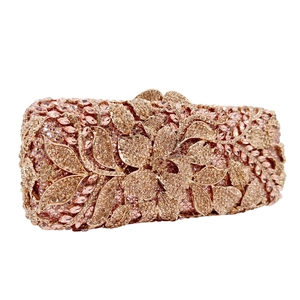 Close-up of champagne floral rhinestone clutch with intricate diamond encrusting detail