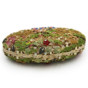Luxury floral crystal clutch bag featuring colorful rhinestones and green enamel leaf detail