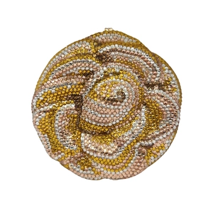 Macro detail of a 3D rose-shaped evening clutch with gold and silver crystal embellishments