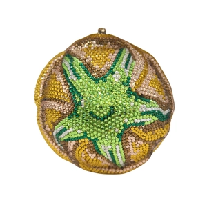 Detailed view of handmade crystal evening clutch featuring a green starfish rhinestone pattern