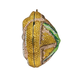 Macro detail of lemon-shaped crystal evening bag with dense yellow rhinestone pavé