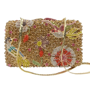 Golden clutch bag with floral bird rhinestone patterns and a metal chain strap