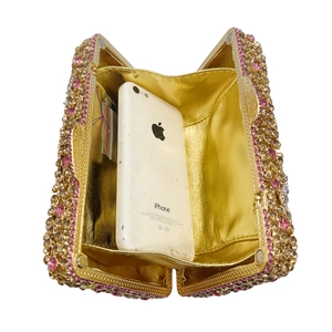 Floral stone clutch evening bag featuring pink gradient rhinestones and inner capacity view