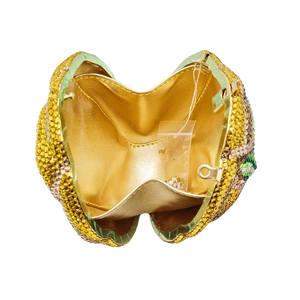 Detail view of the luxury lemon crystal clutch with golden leather lining and spare rhinestones