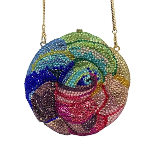 Detail of round evening bag with colorful crystals and a delicate gold chain strap