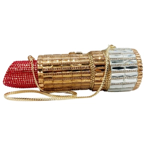 Macro shot of lipstick shaped evening bag featuring sparkling red and gold rhinestones