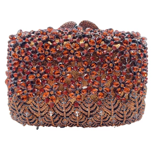 Close-up of amber rhinestones forming flower patterns on a luxury evening clutch bag