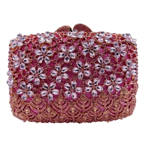Detail of pink crystal floral clutch bag with golden filigree metalwork and luxury rhinestones