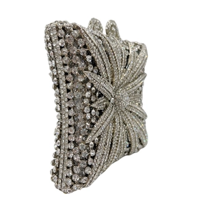 Macro detail of silver rhinestone evening bag showing radial floral pattern and claw setting