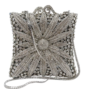 Macro shot of sparkling silver rhinestone evening bag with radiant starburst pattern