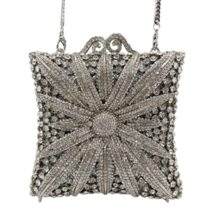 Detail view of silver rhinestone evening bag with sunburst pattern and chain strap