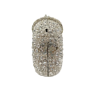 Detailed side view of silver hollow-out evening clutch bag with sparkling rhinestones