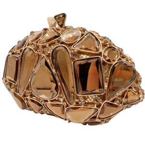 Close-up of golden hollow evening bag featuring amber rhinestones and luxury crystals