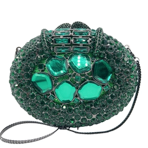 Detail of green rhinestone evening clutch with emerald cut gems and chain strap
