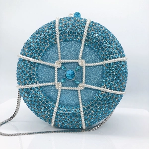 Detail of blue rhinestone evening bag with silver cage overlay and central gemstone