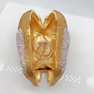 Detail of golden crystal rabbit clutch bag with inner compartment and chain strap