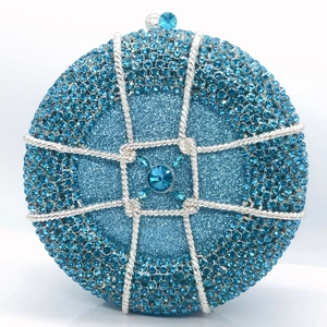 Detailed close-up of sky blue rhinestone evening bag with silver lattice and gemstone