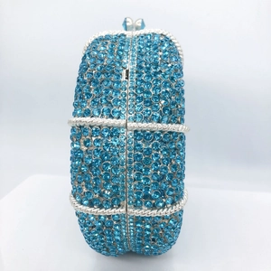 Detail of navy blue rhinestone evening clutch with silver rope metal accents and gemstone clasp