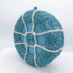 Macro view of blue rhinestone evening bag featuring basketball shape and crystal clasp