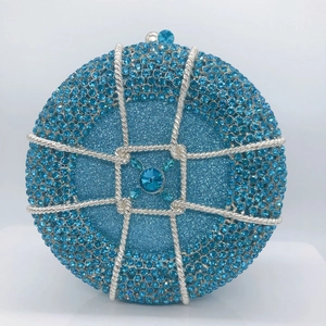 Macro detail of sky blue round evening bag with rhinestones and silver metal trim