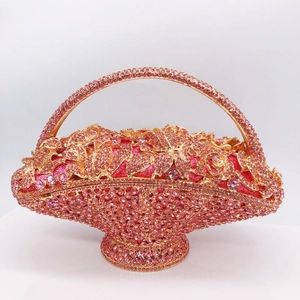 Close-up of luxury flower basket clutch bag with pink rhinestones and gold metal frame