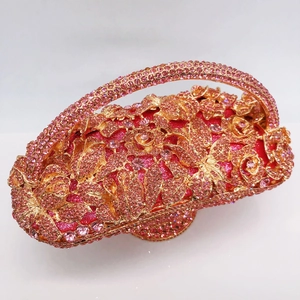 Detailed close-up of a floral basket clutch bag with pink rhinestones and a rose gold frame