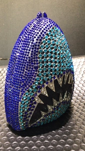 Macro detail of shark shaped clutch bag with sparkling blue and silver rhinestones