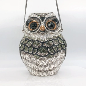 Detailed view of owl-shaped clutch bag featuring intricate rhinestones and silver chain