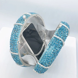 Sparkling blue rhinestone evening clutch bag with round metal frame and silver chain