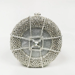 Close-up of circular silver evening bag featuring woven mesh pattern and sparkly rhinestones