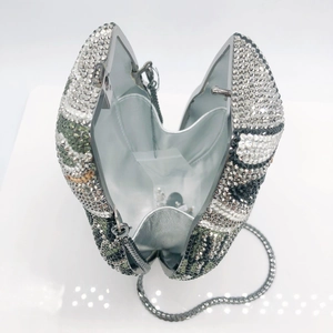 Detail view of the silver metal lining and interior chain of the owl crystal clutch bag