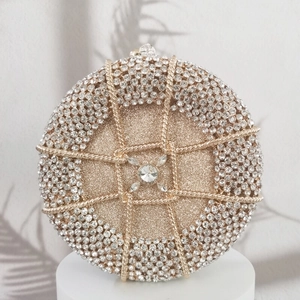 Luxurious gold round evening clutch bag with sparkling crystals and metal spiral pattern