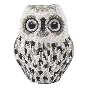 Close-up of owl evening clutch showing silver and black rhinestone feather textures