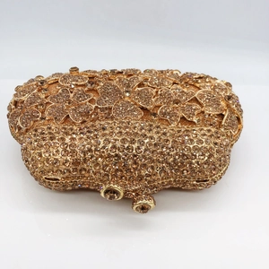 Macro shot of gold floral crystal clutch bag with champagne diamonds and metal clasp
