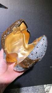 Detailed view of luxury crystal owl clutch bag with golden leather interior and spare rhinestones