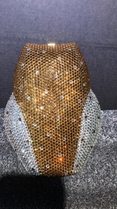 Close-up of sparkling owl clutch bag featuring gold and silver rhinestones and metal clasp
