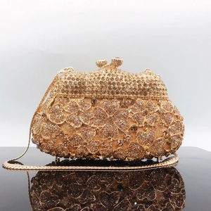 Detailed view of champagne crystal flower clutch bag with gold chain and gem clasp closure