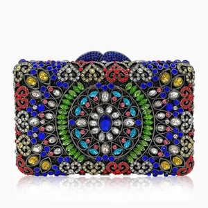 Macro detail of luxury evening clutch bag with multicolored crystals and metal filigree
