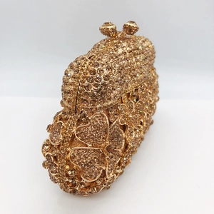 Macro side view of gold floral crystal clutch bag with champagne rhinestones