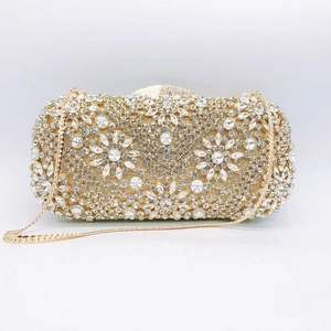 Detailed view of floral crystal patterns on a golden rhinestone evening clutch bag