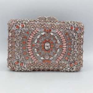 Detail of hollowed metal clutch bag with colorful rhinestones in a floral mandala pattern
