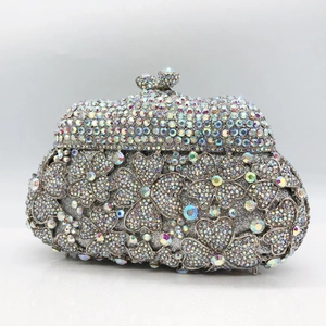 Macro detail of luxury silver flower clutch bag with shimmering crystal rhinestones