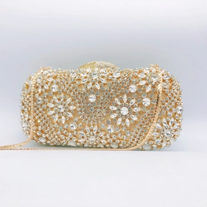 Detailed view of champagne gold evening clutch with radiant rhinestone flower pattern