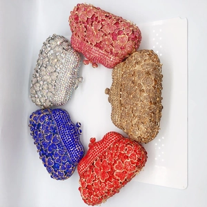 Detail of five colorful crystal clutch bags with 3D flower and butterfly patterns